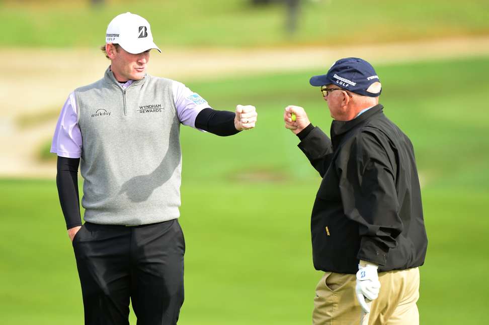 Brandt Snedeker bumps fists with Toby Wilt on the 12th green. Photo: AFP