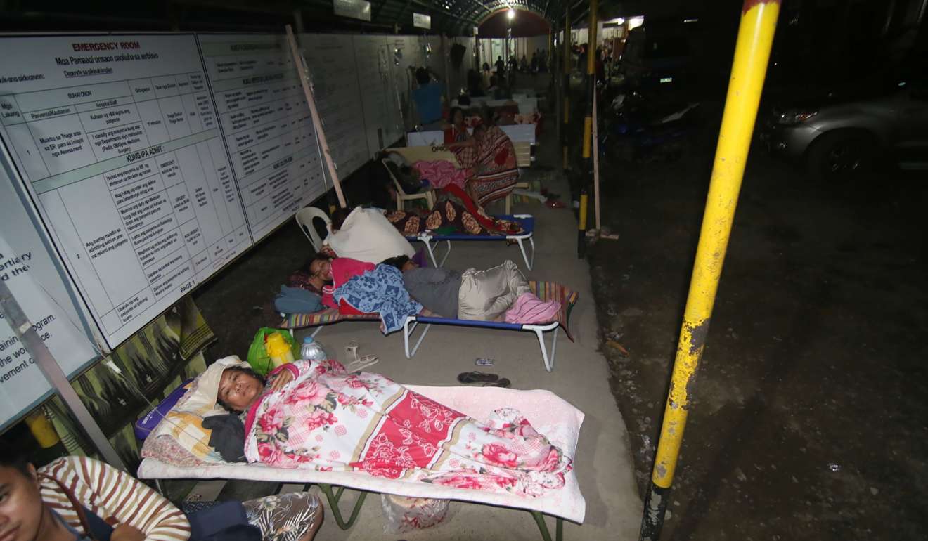 Hospital patients take shelter in a pedestrian-waiting shed after a strong 6 .5-magnitude earthquake struck overnight in the Philippines, killing at least three people. Photo: AFP
