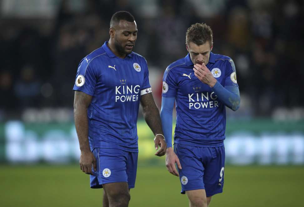 Wes Morgan and Jamie Vardy leave the pitch after the loss to Swansea. Photo: AP
