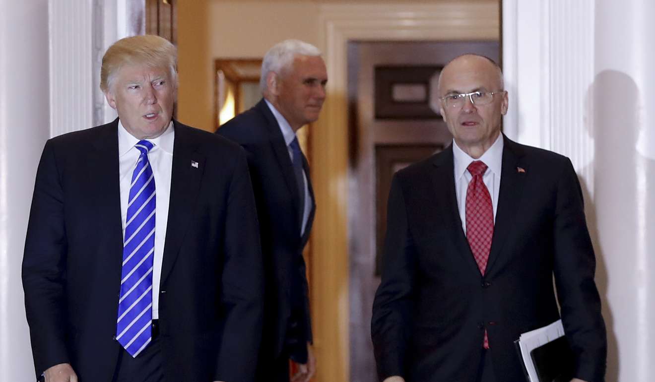 President Donald Trump walks with Labor Secretary-designate Andy Puzder from Trump National Golf Club Bedminster clubhouse in Bedminster, N.J. Puzder said that a housekeeper he had previously employed at his home was an undocumented worker. Photo: AP