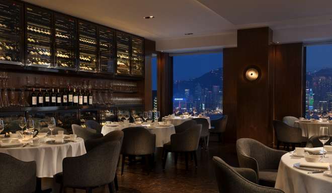Tables by the window at Above & Beyond offer unparalleled views of Victoria Harbour