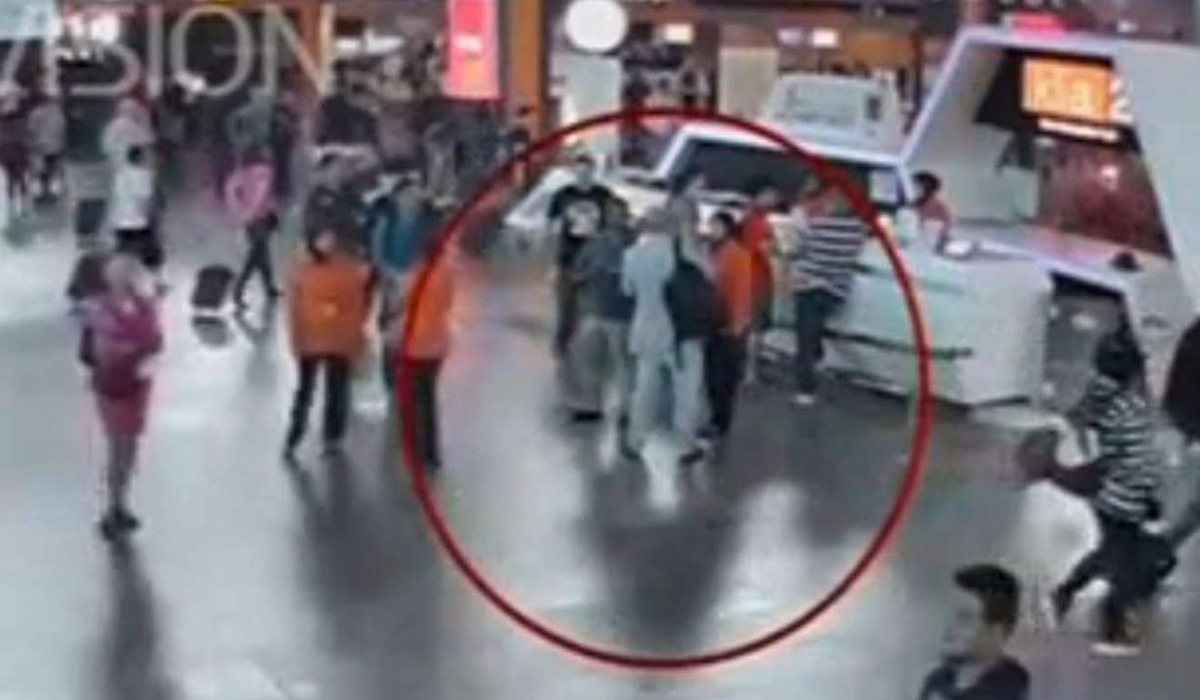 A still image from a CCTV footage appears to shows Kim Jong-nam (circled in red) talking to airport staff, after the February 13 attack. Photo: Reuters