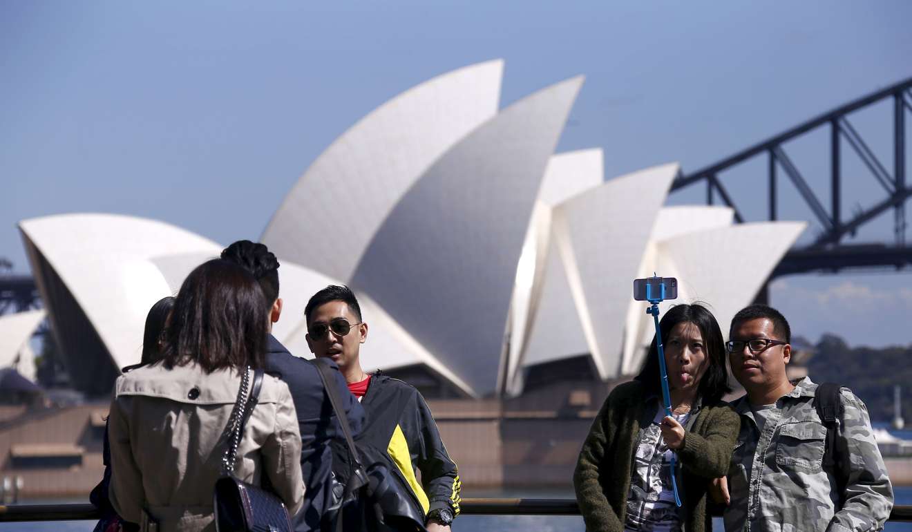Chinese tourists pose for photos in front of two Sydney icons. Photo: Reuters