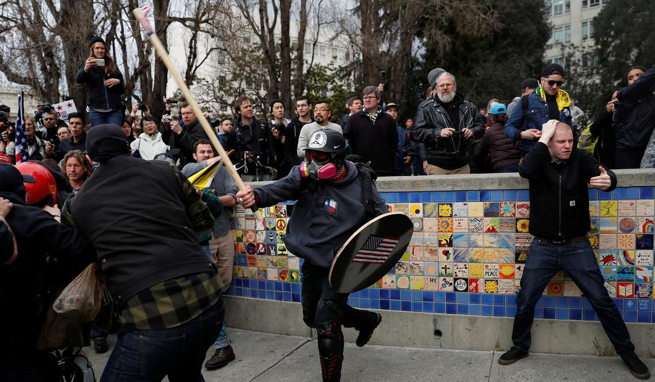 A demonstrator in support of US President Donald Trump swings a stick towards a group of counter-protesters during a ‘People 4 Trump’ rally in Berkeley, California. Photo: Reuters