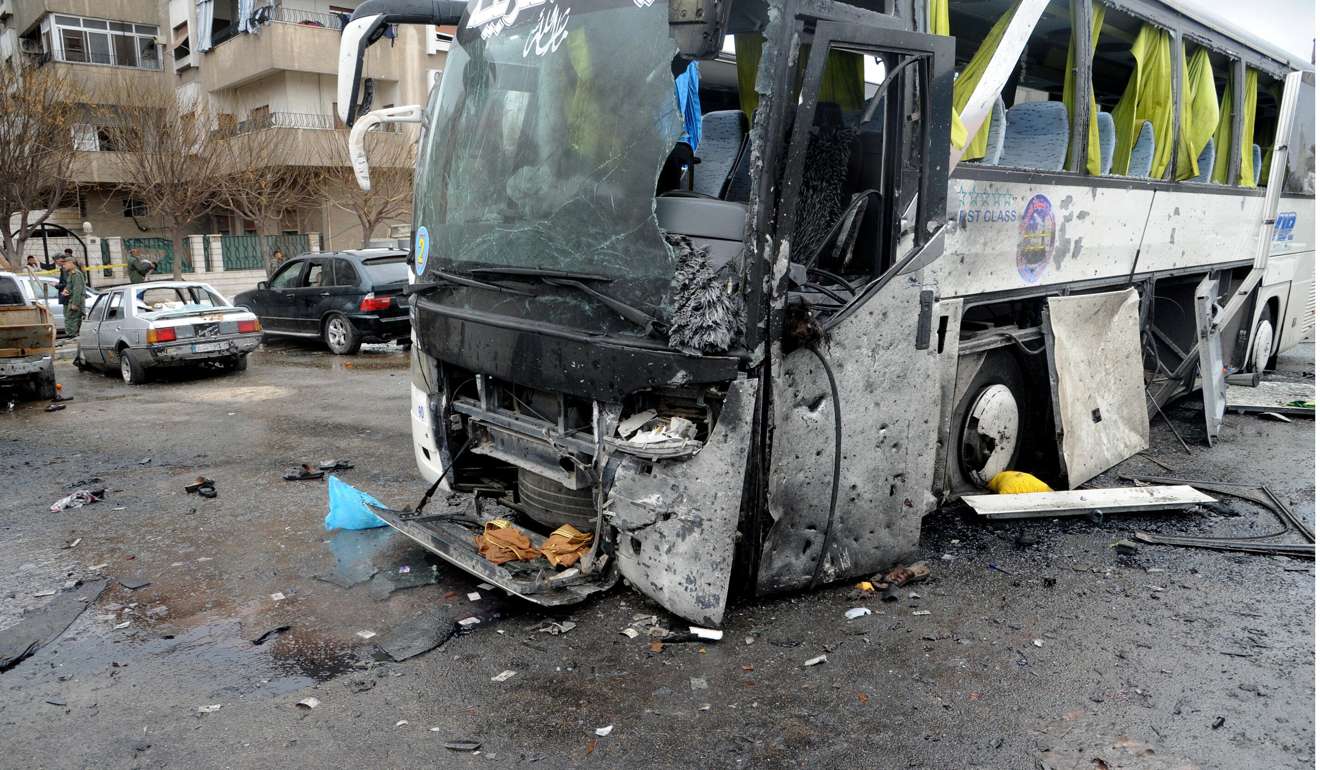 A damaged bus at the site of bombing, in Damascus, Syria. Photo: EPA