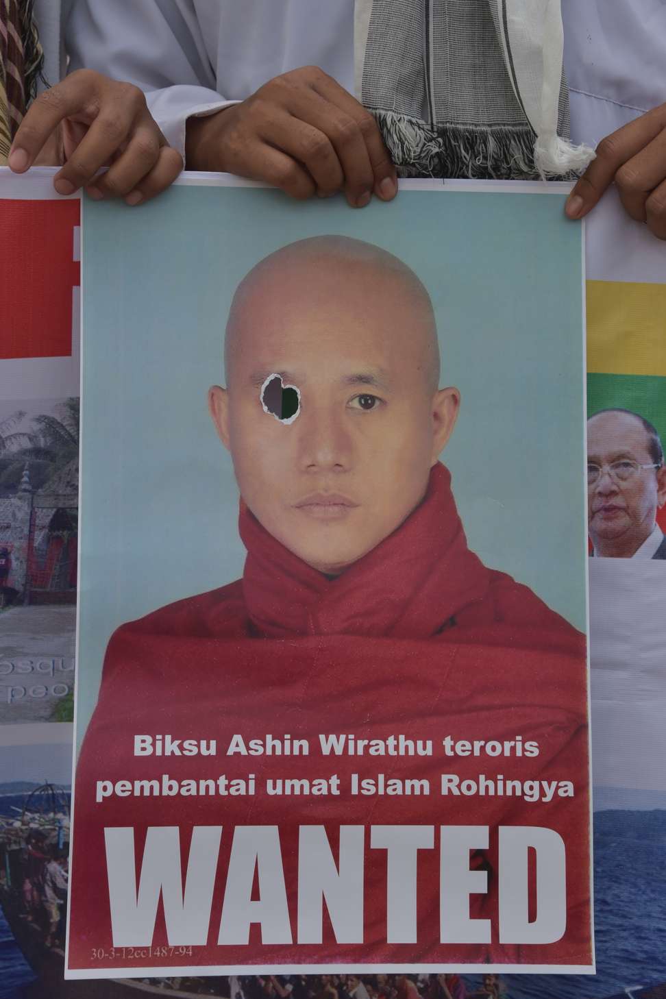 An activist holds a wanted poster of Myanmar hardline Buddhist monk Ashin Wirathu during a rally in support of Rohingya Muslims from Myanmar in Indonesia. File photo: AFP