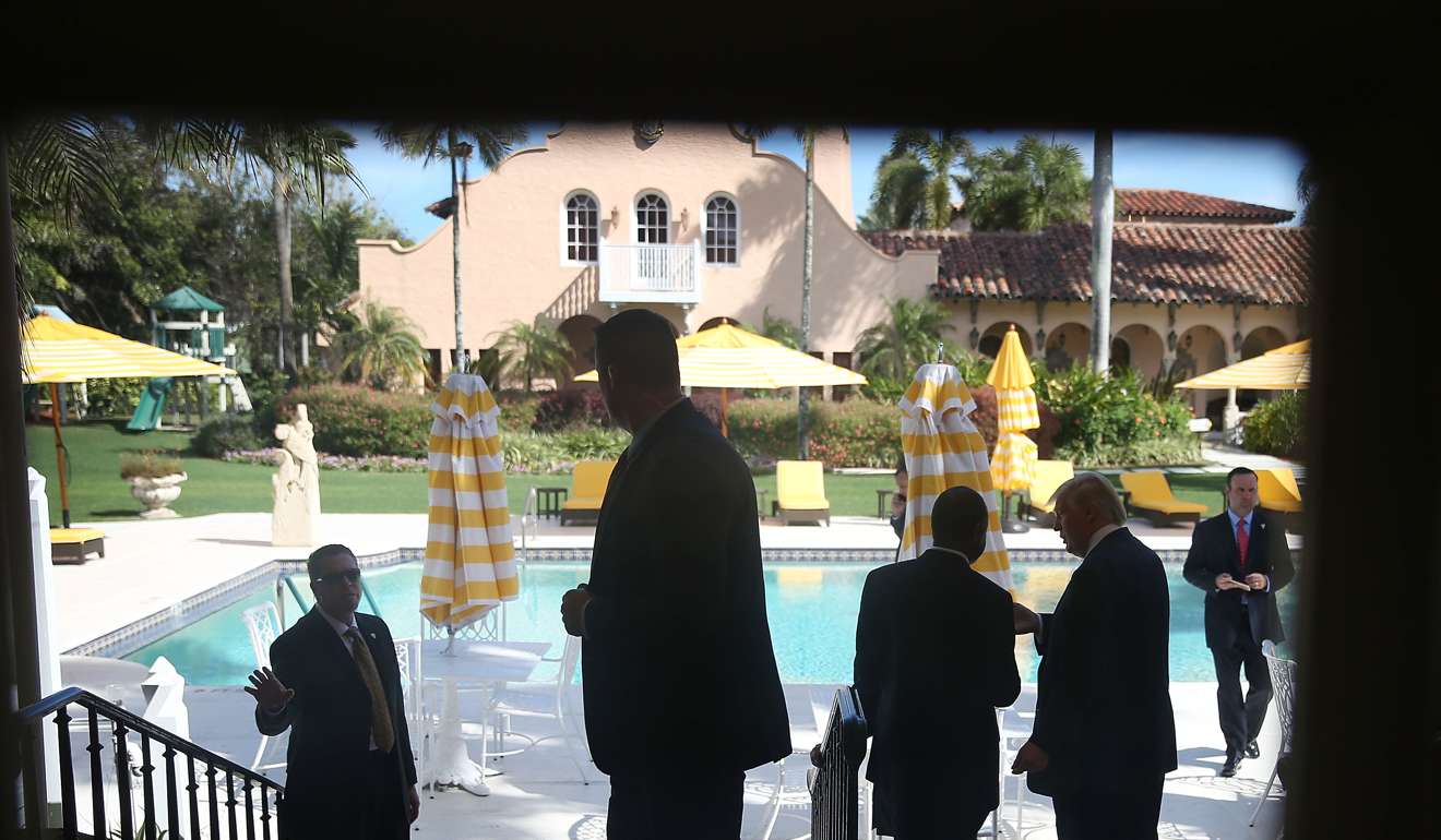 Trump (2nd R) talks with former presidential candidate Ben Carson (3rd L) at the Mar-A-Lago Club on March 11, 2016. Photo: AFP