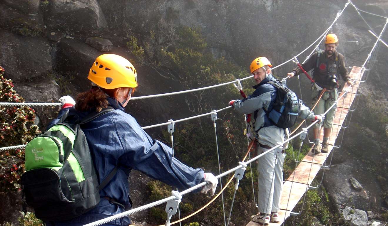 Climbers traverse a bridge atop Mount Kinabalu in Sabah, Malaysia. Photo: Health Post