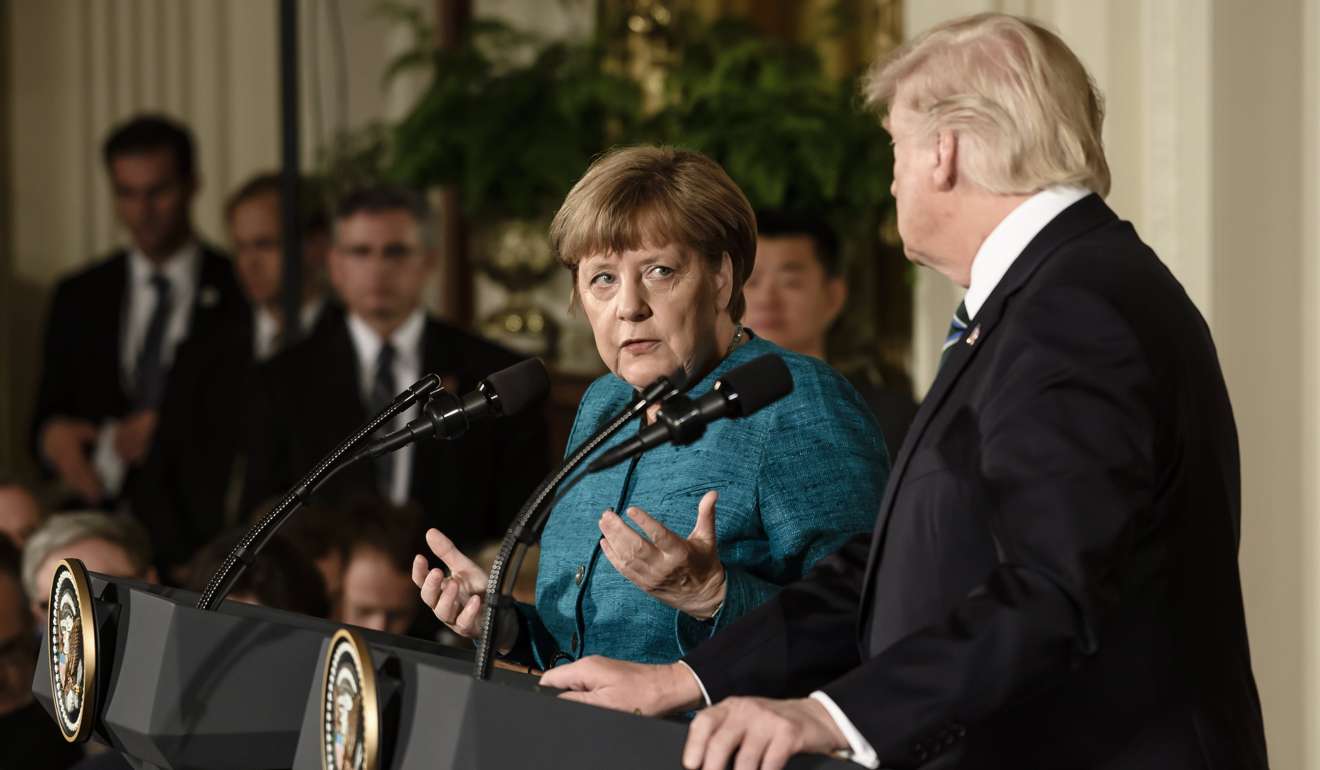 epa05855126 US President Donald J. Trump (R) and German Chancellor Angela Merkel (L) speak during a joint news conference in the East Room of the White House in Washington, DC, USA, 17 March 2017. Merkel's original visit on 14 March had to be postponed due to bad weather. EPA/CLEMENS BILAN