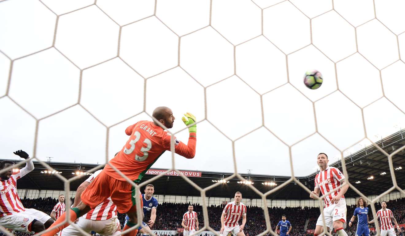Chelsea’s Gary Cahill (centre) shoots and scores past Stoke City goalkeeper Lee Grant. Photo: AFP