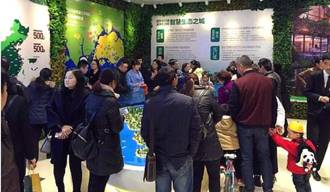 Mainlanders view a model of the Forest City project at the sales centre in Johor, Malaysia. Photo: Handout