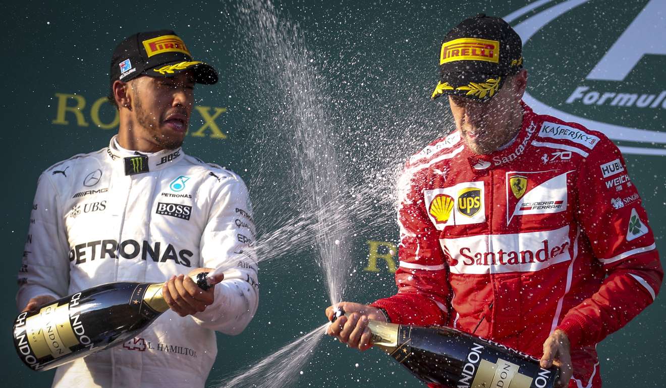 Lewis Hamilton sprays champagne on winner Sebastian Vettel. Photo: EPA