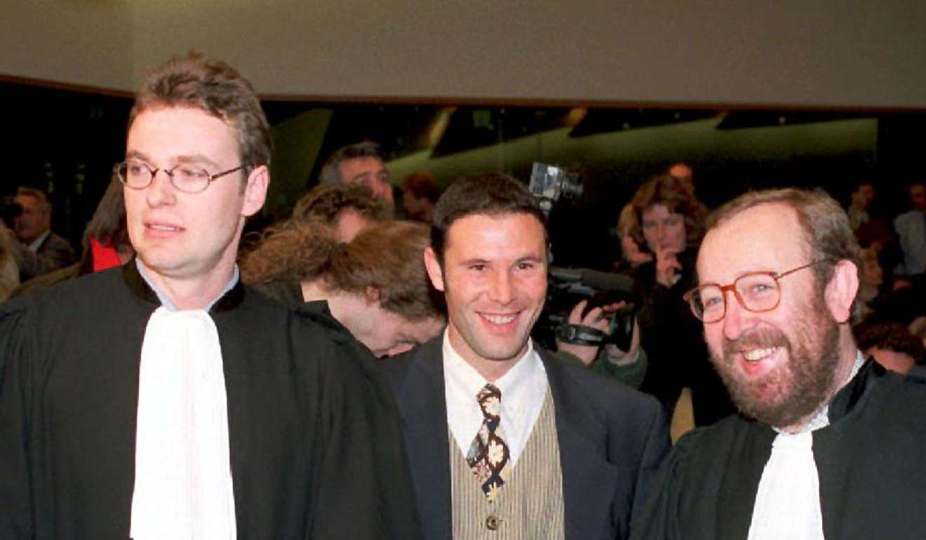 Belgian player Jean-Marc Bosman is flanked by two of his lawyers, Jean-Louis Dupont (left) and Luc Misson, after the European Court of Justice ruled in December 1995 that the transfer system of players between football clubs was illegal. Photo: AFP
