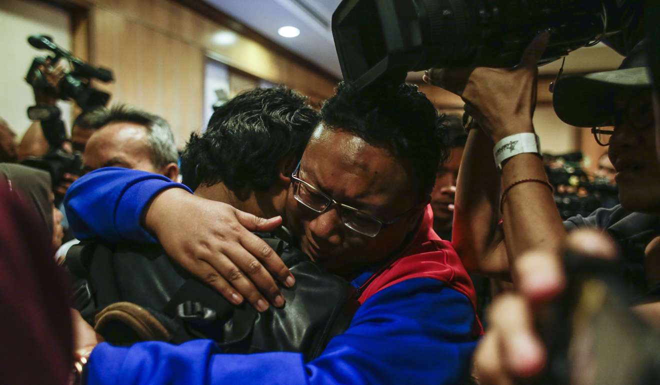 One of nine Malaysian nationals released from North Korea hugs a family member upon arriving at Kuala Lumpur International airport in Sepang on Friday. Photo: EPA