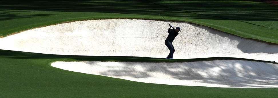 Russell Henley hits from a sand bunker along the 8th fairway during the first round. Photo: TNS