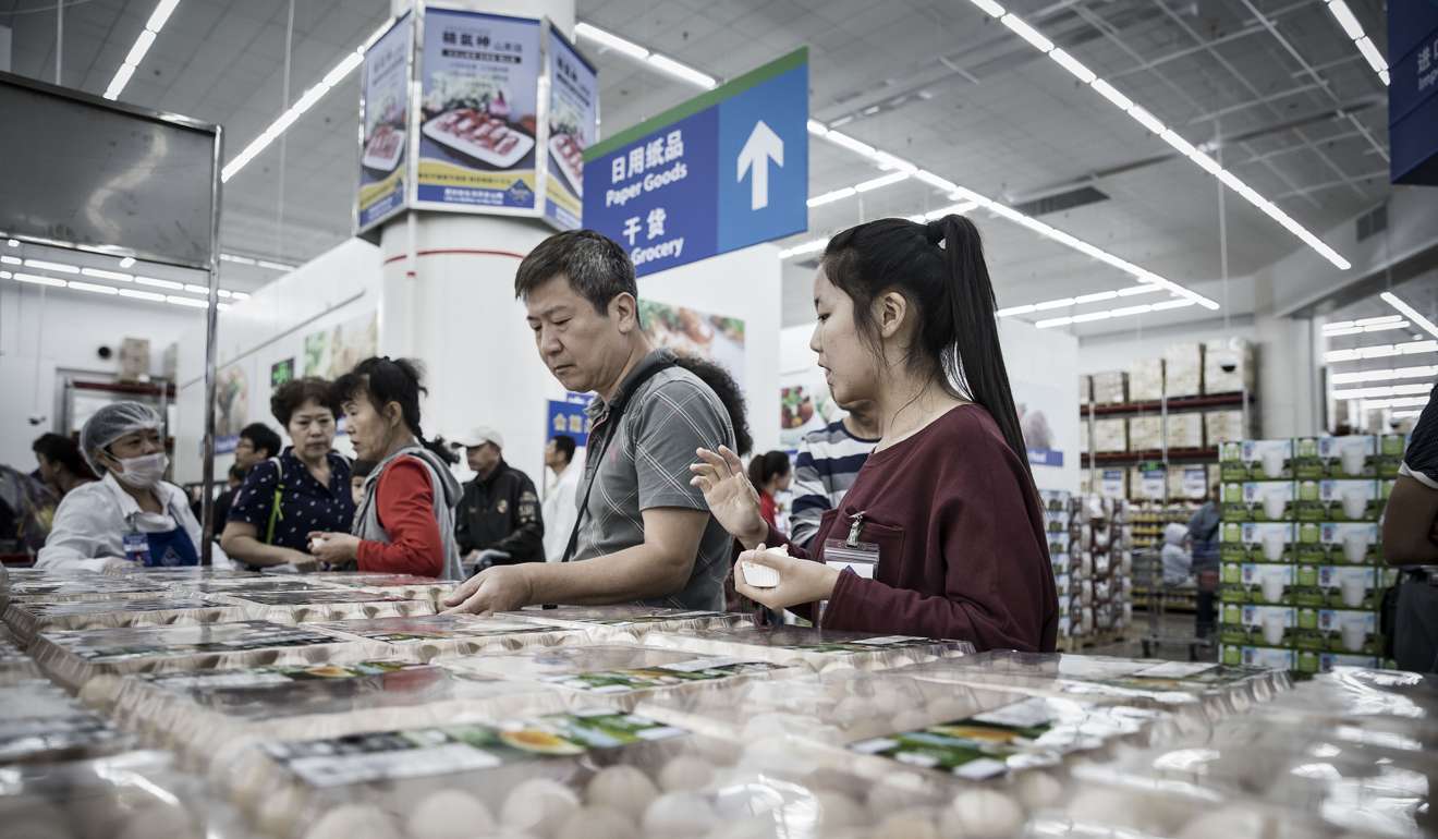 Customers look at a packaged eggs in a fresh produce section of a Wal-Mart Store in Tianjin, China. In 2015, investment made up 43.3 per cent of China’s gross domestic product, while household consumption was only 38 per cent. Photo: Bloomberg