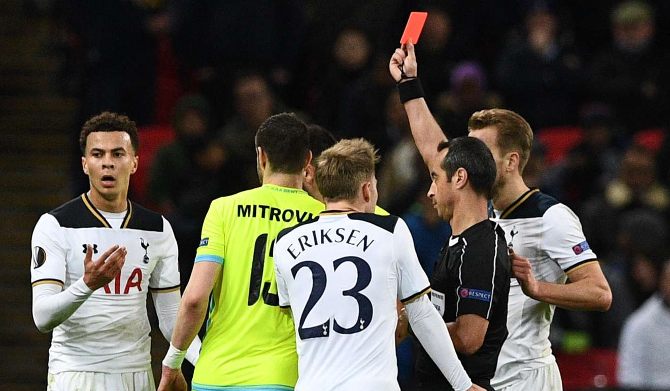 Portuguese referee Jorge Sousa (right) shows a straight red card to send off Tottenham Hotspurs midfielder Dele Alli (left). Photo: AFP