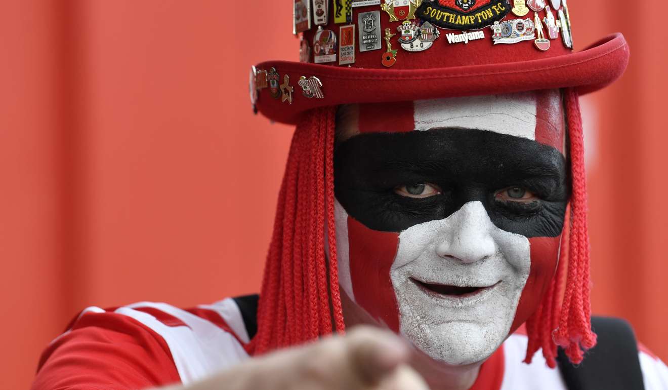 A diehard Southampton fan, complete with costume and colours. The Saints currently sit ninth on the English Premier League table.