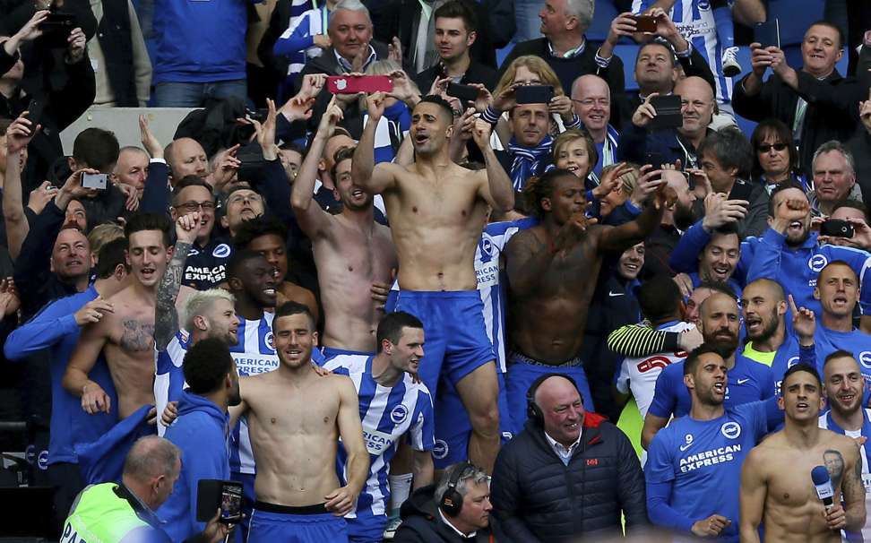 Brighton and Hove Albion players and fans celebrate promotion. Photo: AP