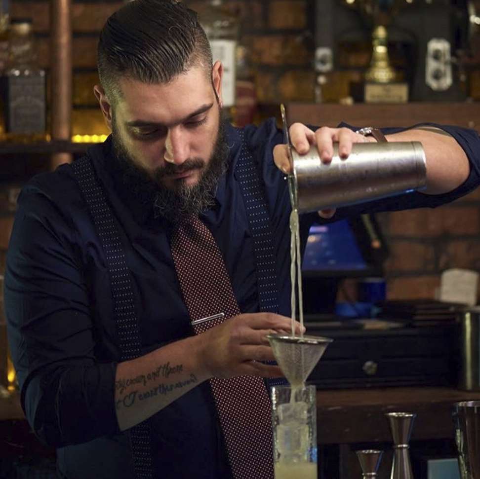 A bartender pours a cocktail at Seamstress. Photo: courtesy of Seamstress