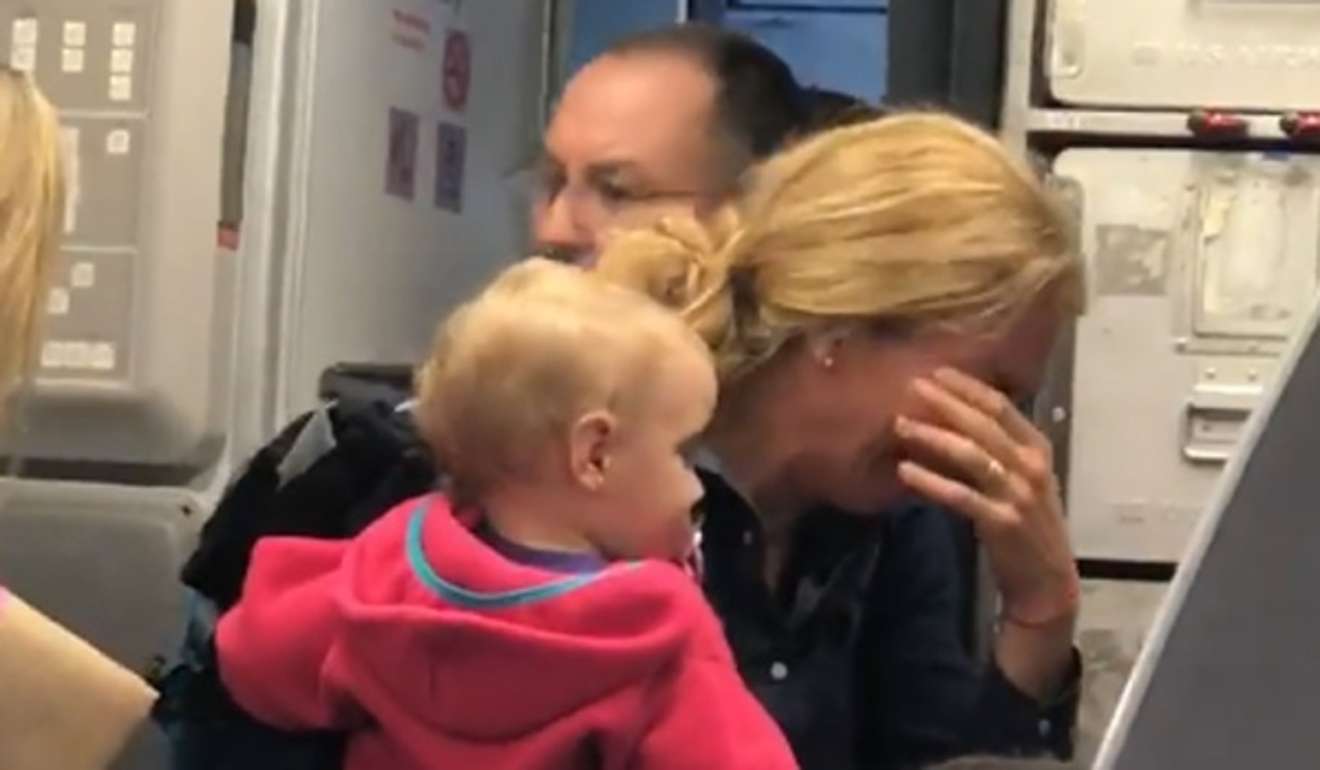 The passenger with the baby can be seen ducking out of the way, shielding her baby’s head. Photo: Twitter