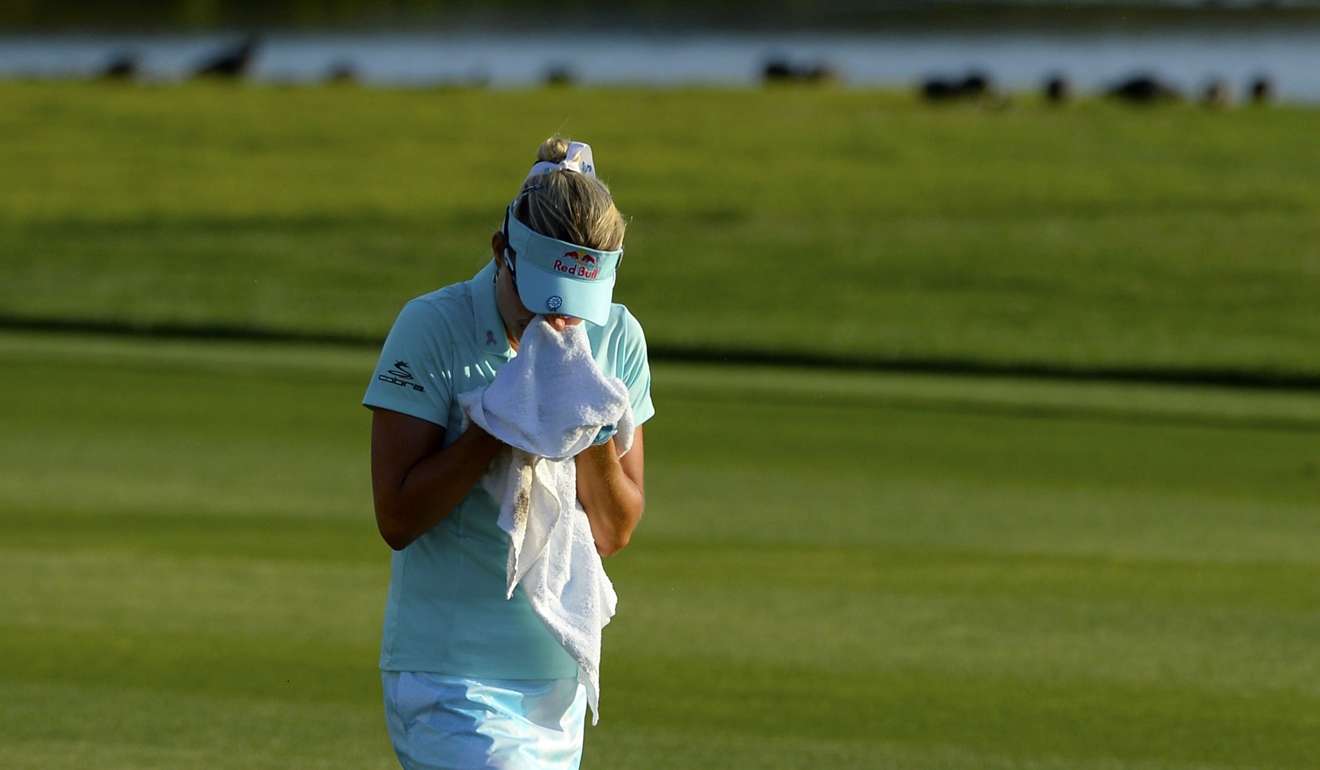 Lexi Thompson cries in a towel as she walks during the final round of the ANA Inspiration. Photo: AFP