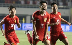 China’s Huang Bowen (second right) celebrates with teammates after scoring against Qatar in Xian. China’s 2-0 win sees them advance to the next round. Photo: Xinhua