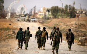 Kurdish Peshmerga forces walk towards the town of Bashiqa, east of Mosul, during an operation to attack Islamic State militants in Mosul, Iraq. Canadian troops have been training the Kurdish forces, and sometimes fighting alongside them. Photo: Reuters