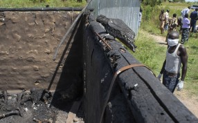 A man collecting bodies to bury in a mass grave approaches a burned hut containing charred corpses, on the outskirts of Yei, in southern South Sudan. Photo: AP A man collecting bodies to bury in a mass grave approaches a burned hut containing charred corpses, on the outskirts of Yei, in southern South Sudan. Photo: AP