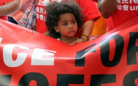 A child holding a banner during a rally in support of World Refugee Day 2016 in Central earlier this year. Photo: Edward Wong