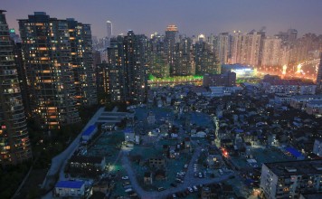 A night view of the old houses surrounded by new apartment buildings at Guangfuli neighbourhood in Shanghai, China. Photo: Reuters, Aly Song