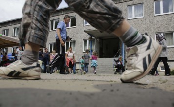 People attend a summer party at an accommodation for migrants where Halima Taha works as a translator. Photo: AP