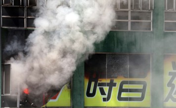 The flames take hold at Amoycan Industrial Centre on Ngau Tau Kok Road on June 21. Two firefighters died in the blaze, and more than 200 mini-storage cubicles were destroyed. Photo: Felix Wong, SCMP