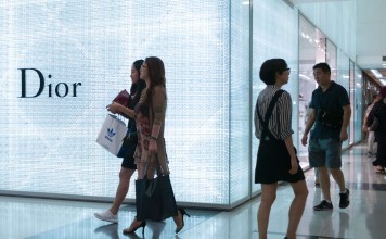 People walk past a store front in a shopping mall in Beijing. Premier Li Keqiang has twice said recently economic growth remained steady in the second quarter. Photo: AFP