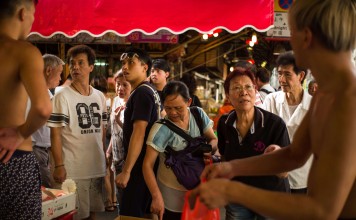 Vendors sell fruit at a street market. Nobody in Hong Kong is “entitled” to a livelihood and we all work hard to pay our bills. Photo: AFP Vendors sell fruit at a street market. Nobody in Hong Kong is “entitled” to a livelihood and we all work hard to pay our bills. Photo: AFP