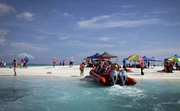 Chinese tourists visiting one of the Paracel Islands in a disputed area of the South China Sea. Photo: AP Chinese tourists visiting one of the Paracel Islands in a disputed area of the South China Sea. Photo: AP