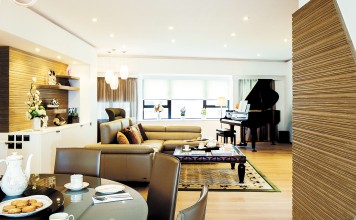 Curvaceous walls and wood panels turn spacious Macdonnell Road apartment into a cohesive, functional space