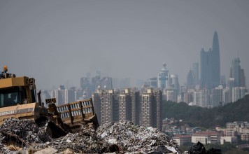 Shenzhen tower blocks loom over a landfill in the New Territories, Hong Kong. Nearly 40 per cent of the city’s municipal solid waste is composed of food. Photo: AFP