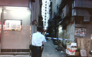 The boy was found by neighbours lying unconscious in a back alley of Man Shing Building shortly before 5pm on Tuesday. Photo: SCMP Pictures