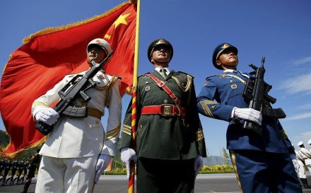 Officers and soldiers of China's People's Liberation Army hold a flag and weapons during a training session for a military parade to mark the 70th anniversary of the end of the World War Two, at a military base in Beijing, China, August 22, 2015. Troops from at least 10 countries including Russia and Kazakhstan will join an unprecedented military parade in Beijing next month to commemorate China's victory over Japan during World War Two, Chinese officials said. The parade on Sept. 3 will involve about 12,000 Chinese troops and 200 aircraft, Qi Rui, deputy director of the government office organizing the parade, told reporters in Beijing on Friday. REUTERS/Damir Sagolj Officers and soldiers of China's People's Liberation Army hold a flag and weapons during a training session for a military parade to mark the 70th anniversary of the end of the World War Two, at a military base in Beijing, China, August 22, 2015. Troops from at least 10 countries including Russia and Kazakhstan will join an unprecedented military parade in Beijing next month to commemorate China's victory over Japan during World War Two, Chinese officials said. The parade on Sept. 3 will involve about 12,000 Chinese troops and 200 aircraft, Qi Rui, deputy director of the government office organizing the parade, told reporters in Beijing on Friday. REUTERS/Damir Sagolj