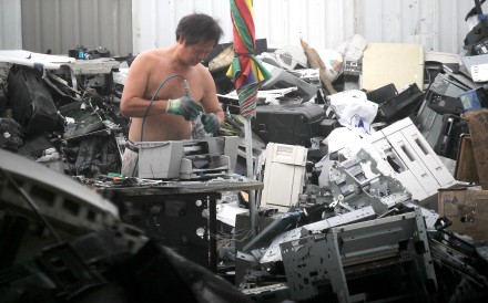 An e- waste recycler at Ping Che, Ta Kwu Ling works without safety gear. Photo: SCMP Pictures