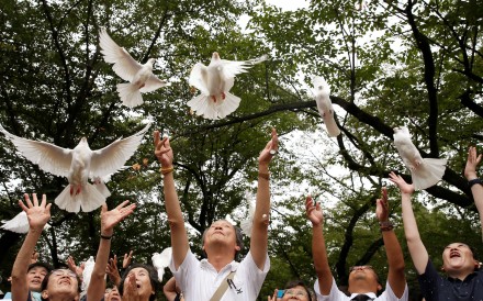 People release doves as a symbol of peace at the Yasukuni Shrine in Tokyo, in August 2016, to mark the anniversary of the end of the second world war. Photo: Reuters