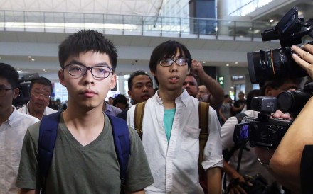 Joshua Wong (centre) arriving back at Hong Kong International Airport after being detained by Thai authorities and denied entry to Thailand. Photo: Sam Tsang