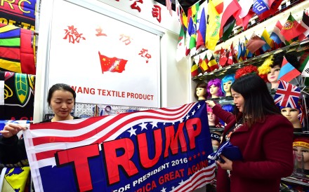 A shop assistant with a pro-Trump banner at the China Yiwu International Trade City. Photo: AFP A shop assistant with a pro-Trump banner at the China Yiwu International Trade City. Photo: AFP