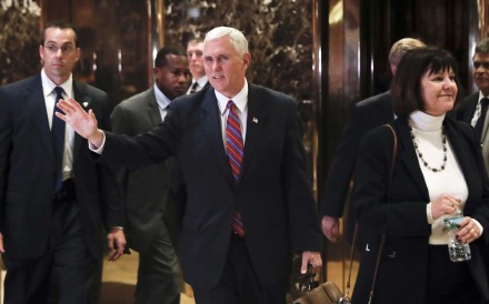Vice President-elect Mike Pence waves to the media as he leaves Trump Tower in New York with his wife Karen, on Tuesday. Photo: AP Vice President-elect Mike Pence waves to the media as he leaves Trump Tower in New York with his wife Karen, on Tuesday. Photo: AP