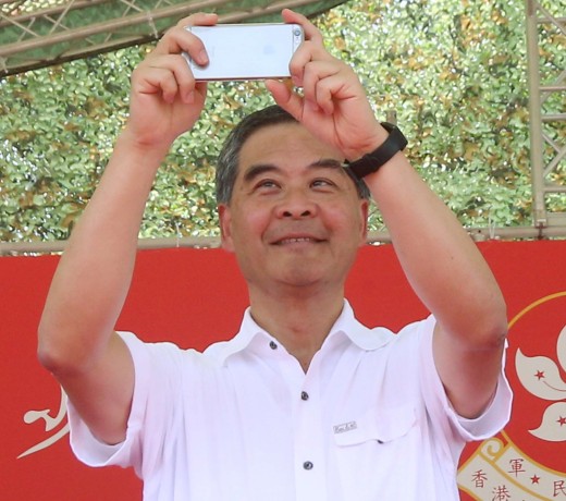 Chief Executive Leung Chun-ying takes some pictures on his phone at the graduation ceremony for military summer camp for HK youth in San Wai Barracks in Fanling.Photo: David Wong