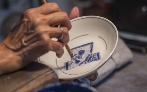 A craftswoman at work at in Yuet Tung China Works.