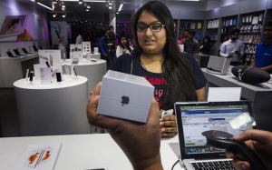 Aarushi, the first customer to buy an Apple Inc. iPhone 6s at an iZenica store, operated by Zenica LifestylePvt., waits to pay during a midnight launch event for the iPhone 6s in New Delhi, India in October, 2015. Photo: Prashanth Vishwanathan/Bloomberg/Getty Images