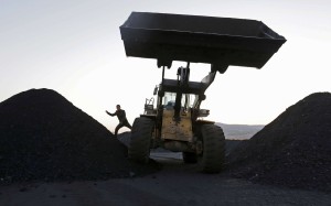 A file picture of workers operating an excavator at a coal depot in Heilongjiang province. Photo: Reuters