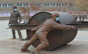 Statues, given masks during a heavy pollution day by students, are seen on a university campus on Shenyang, Liaoning province. Photo: ImagineChina